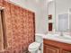 Clean bathroom featuring a single sink vanity and a shower-tub combination with a decorative curtain at 43510 N 44Th Ave, New River, AZ 85087