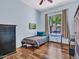 Bright bedroom featuring wood floors, a window view and blue accents at 43510 N 44Th Ave, New River, AZ 85087