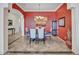 Elegant dining room with modern chandelier, stylish artwork, and ample seating for formal gatherings at 43510 N 44Th Ave, New River, AZ 85087