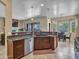 Open concept kitchen with stainless steel appliances, tile flooring, and a view into the living and dining areas at 43510 N 44Th Ave, New River, AZ 85087