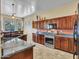 Modern kitchen with stainless steel appliances, granite countertops, and custom cabinets with a breakfast bar at 43510 N 44Th Ave, New River, AZ 85087