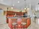 Stylish kitchen featuring breakfast bar with pendant lights, granite countertops, and stainless steel appliances at 43510 N 44Th Ave, New River, AZ 85087