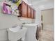 Bright laundry room features a utility sink, overhead cabinets, and modern washer and dryer at 43510 N 44Th Ave, New River, AZ 85087
