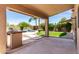Covered patio features a grill overlooking the lush backyard and sparkling pool at 4426 E Coyote Wash Dr, Cave Creek, AZ 85331