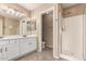 Bathroom view showcasing dual sinks, a walk-in shower, and a separate toilet area with tile flooring at 4426 E Coyote Wash Dr, Cave Creek, AZ 85331