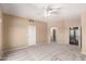 Spacious carpeted bedroom with neutral walls, ceiling fan, and en-suite bathroom at 4426 E Coyote Wash Dr, Cave Creek, AZ 85331