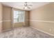 Cozy bedroom features neutral carpet, paint, a ceiling fan, and a window with natural light at 4426 E Coyote Wash Dr, Cave Creek, AZ 85331