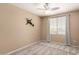 Comfortable bedroom featuring a ceiling fan, carpet flooring and a window offering natural light at 4426 E Coyote Wash Dr, Cave Creek, AZ 85331