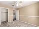 This carpeted bedroom features a ceiling fan and access to an ensuite bathroom and walk-in closet at 4426 E Coyote Wash Dr, Cave Creek, AZ 85331