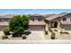 Charming home featuring a symmetrical facade, lush front yard landscaping, and a two-car garage at 4426 E Coyote Wash Dr, Cave Creek, AZ 85331