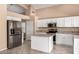 Bright kitchen features stainless appliances and white cabinetry at 4426 E Coyote Wash Dr, Cave Creek, AZ 85331
