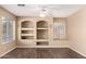 Bright living room with built-in shelves, ceiling fan, and large windows at 4426 E Coyote Wash Dr, Cave Creek, AZ 85331