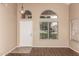 Living room with wood floors, chandelier, neutral paint, and arched windows at 4426 E Coyote Wash Dr, Cave Creek, AZ 85331