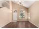 Entryway featuring wood floors, staircase, chandelier, neutral paint, vaulted ceilings, and arched windows at 4426 E Coyote Wash Dr, Cave Creek, AZ 85331