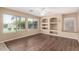 Bright living space with large windows overlooking the backyard and a built-in shelving unit at 4426 E Coyote Wash Dr, Cave Creek, AZ 85331