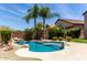 A beautiful pool is showcased surrounded by desert landscape and mature palm trees at 4426 E Coyote Wash Dr, Cave Creek, AZ 85331