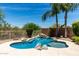 A beautiful pool is showcased surrounded by desert landscape and mature palm trees at 4426 E Coyote Wash Dr, Cave Creek, AZ 85331