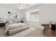 Serene bedroom with soft neutral tones, a ceiling fan, and a window nook with shutters at 4734 W Golden Ln, Glendale, AZ 85302