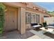 Inviting front patio with neutral tones, stylish outdoor seating, and tiled flooring at 4734 W Golden Ln, Glendale, AZ 85302