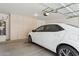 Garage with storage cabinets, water heater, and white car parked inside at 4734 W Golden Ln, Glendale, AZ 85302