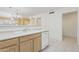 Bright kitchen features light wood cabinetry, white appliances and opens to the living area with a bar top at 4734 W Golden Ln, Glendale, AZ 85302