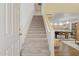 Bright foyer features a carpeted staircase leading to the upper level, next to an open-concept dining area at 4734 W Golden Ln, Glendale, AZ 85302