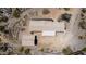 An aerial view showcases the house, auxiliary structure, and surrounding desert landscape at 48451 N 27Th Ave, New River, AZ 85087