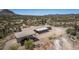 An aerial view of a property with a carport and desert landscape at 48451 N 27Th Ave, New River, AZ 85087
