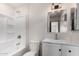Bathroom with white tub, white vanity, brushed nickel faucet and white toilet at 48451 N 27Th Ave, New River, AZ 85087