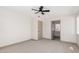 Bright bedroom features carpeted floors, light neutral walls, a ceiling fan, and plenty of light at 48451 N 27Th Ave, New River, AZ 85087