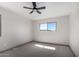 Bright bedroom featuring neutral walls, carpet flooring, base trim, and a large window with natural light at 48451 N 27Th Ave, New River, AZ 85087