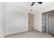 Bedroom featuring neutral walls, carpet flooring, base trim, closet, and door at 48451 N 27Th Ave, New River, AZ 85087
