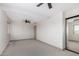 A bedroom with light neutral walls, carpeted floors, ceiling fans and a mirrored closet at 48451 N 27Th Ave, New River, AZ 85087