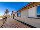A home exterior with a dark brown wooden deck, and plenty of windows for ample natural light at 48451 N 27Th Ave, New River, AZ 85087