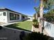 Backyard with artificial turf, modern fence, and tiled patio, offering low maintenance outdoor living space at 5088 S Ponderosa Dr, Gilbert, AZ 85298