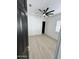 Bright bedroom featuring a modern ceiling fan, neutral walls, and wood-look flooring at 5088 S Ponderosa Dr, Gilbert, AZ 85298