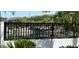 Scenic view of community pond with a black iron fence and lush landscaping, creating a peaceful and inviting outdoor space at 5088 S Ponderosa Dr, Gilbert, AZ 85298