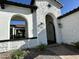 Detailed view of the stone entrance, showing the archway, iron gate, and landscaped surroundings at 5088 S Ponderosa Dr, Gilbert, AZ 85298