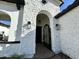 Close-up of the front entrance with a detailed stone archway and an ornate iron gate at 5088 S Ponderosa Dr, Gilbert, AZ 85298