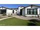 Beautiful home featuring a well-manicured lawn, a stone facade, a tile roof, and a welcoming walkway at 5088 S Ponderosa Dr, Gilbert, AZ 85298