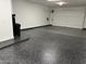 Spacious garage with epoxy flooring and white walls, ready for your vehicles and storage needs at 5088 S Ponderosa Dr, Gilbert, AZ 85298