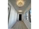 Bright hallway featuring modern light fixtures, hardwood flooring, and window views at 5088 S Ponderosa Dr, Gilbert, AZ 85298
