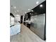 Spacious kitchen with modern stainless steel appliances, an island with white marble countertops, and sleek black cabinets at 5088 S Ponderosa Dr, Gilbert, AZ 85298