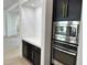 Built-in stainless steel microwave and oven set in a modern kitchen with wine rack at 5088 S Ponderosa Dr, Gilbert, AZ 85298