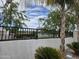 Community lake viewed from behind a block wall and a decorative metal fence at 5088 S Ponderosa Dr, Gilbert, AZ 85298