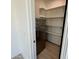 Spacious walk-in pantry with ample shelving and stainless steel refrigerator providing additional storage space at 5088 S Ponderosa Dr, Gilbert, AZ 85298