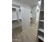 Bright walk-in closet with custom shelves and ample storage space at 5088 S Ponderosa Dr, Gilbert, AZ 85298