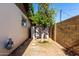 Backyard featuring a mature tree, storage shed, and secure brick fence at 518 N Cheri Lynn Dr, Chandler, AZ 85225