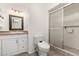 Well-lit bathroom with vanity, a frameless glass shower, tile floor and low-flow toilet at 518 N Cheri Lynn Dr, Chandler, AZ 85225