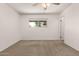 The empty bedroom features a carpeted floor, a ceiling fan, a window and neutral walls at 518 N Cheri Lynn Dr, Chandler, AZ 85225